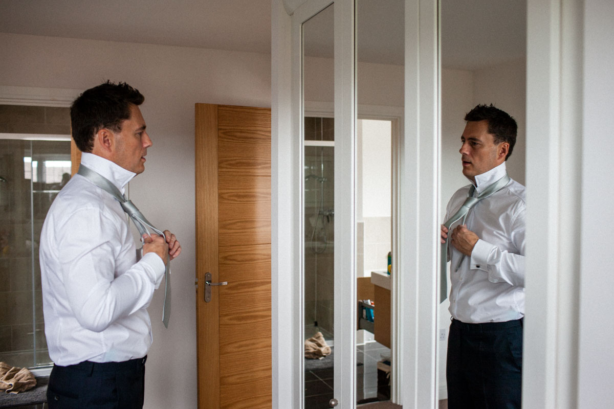 Use mirrors to add depth and interest to preparation shots of the groom